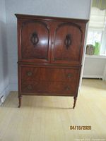 Front view of dresser showing upper cabinet doors and lower drawers