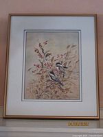 Framed watercolor painting showing full image of two chickadees on branches with berries, in light wood frame with white mat.