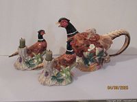 Full view of the set including one pheasant pitcher and two matching pheasant candle holders with green taper candles.