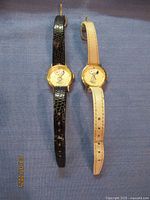 Two vintage Armitron Snoopy watches side by side showing both watch faces and straps.