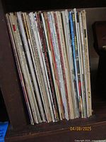Shelf of assorted vintage vinyl records with various spine labels.