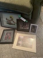 Group of six framed artwork pieces showing variety including animals and nature scenes.