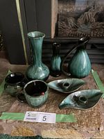 Full lot showing all items: 2 candlestick holders, small cup with ladybug, jug, vase, 2 bud vases