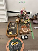 Wide photo showing the collection including clocks, gnomes, and floral arrangements on the floor