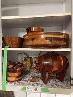 Wooden bowls, wooden keg on stand, and wooden egg cups on shelf.
