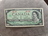 Front side of the 1967 Canadian one dollar banknote featuring Queen Elizabeth II and commemorative text for the Centennial of Canadian Confederation.