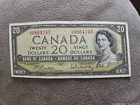 Front side of the 1954 Canadian $20 banknote showing Queen Elizabeth II and serial numbers.