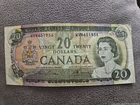 Obverse side of the 1969 Canadian $20 banknote showing Queen Elizabeth II portrait, serial number WV4651956, signatures, and denomination text in English and French.