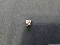 Front view of Pandora sterling silver Celtic knot charm on black background showing detailed design