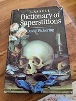 Front cover of the book showing title, author, and decorative artwork with a skull and candle.