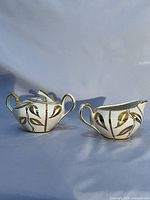 Cream pitcher and lidded sugar bowl frontal view