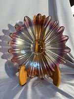 Front view of scalloped sunburst platter on stand