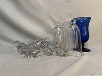 Group view of crystal birds, pipe rests, bell jars, cobalt vase