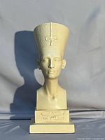 Front view of cream Durastone Nefertiti bust on plinth