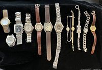 All twelve watches laid out on black background