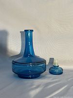 Full view of blue glass decanter and stopper