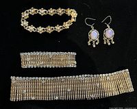 Full lot showing necklace, bracelet, floral bracelet and earrings