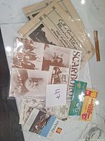 Lot of Canadian ephemera including Scarboro Community Guide 1978 and old documents in plastic sleeves on a marble surface