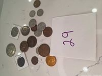 All coins displayed on white surface showing size, condition, and variety.