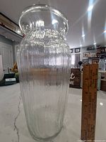 Clear vintage ribbed glass vase shown next to a ruler indicating size and texture detail.
