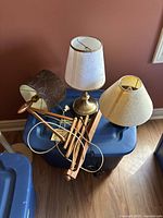 Three lamps grouped together on a blue storage bin showing the overall lot contents