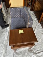 Front hall bench seat, blue patterned upholstery with wooden frame and drawer, shown with adjacent furniture pieces.