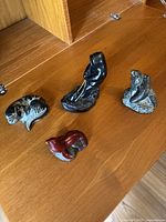 Top view showing all four soapstone animal carvings placed on wooden surface.