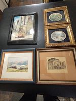 Five framed prints including cityscape with tram, two small oval ship prints in ornate gold frames, mountain landscape and architectural drawing prints.