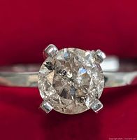 Top view of the round brilliant diamond, prong mount and part of the band