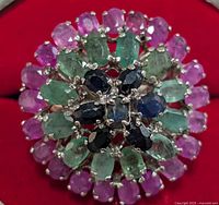 Top close-up view of the ring showing the multicolored gemstone cluster arranged in a floral pattern.