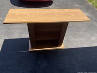 Front and top view of the wood hall/TV table showing flat surface, central shelf, and base.