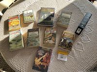 Overview of Tolkien books including The Hobbit, Lord of the Rings, gamebooks, and sealed audio set, arranged on tablecloth