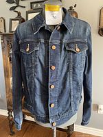 Front view of the ladies Levi Strauss jean jacket on mannequin showing button closures and chest pockets.