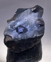 Large garnet crystals embedded in white quartz matrix with dark green epidote and pyrite crystals visible.