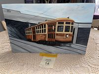 Full view of the original painting showing the streetcar from a front-side angle on the canvas with clear artist signature and year 1916.