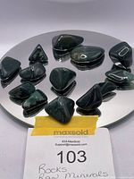 15 pieces of hand-tumbled bloodstone samples displayed on a round mirror base.