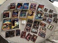 Overview showing Star Trek paperback novels laid out with multiple vintage trading cards arranged alongside them on a table.
