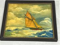 Full view of the framed acrylic realism painting showing a sailboat with orange sails on blue-green ocean waves under a cloudy sky.