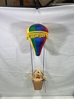 Full view of the hanging plush hot air balloon with teddy bear in basket
