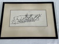 Framed abstract ink drawing of five bulls or cows on mat board inside a black frame