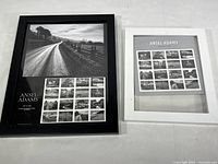 Two framed Ansel Adams nature stamp sheets side by side, black frame on left, white frame on right.