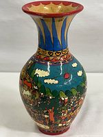 Front view of the vintage Mexican handpainted terra cotta vase with colorful folk art depicting villagers and animals under a bright sky.