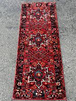 Full view of the vintage Hamadan runner rug, showing its overall red base color and bordered geometric pattern.