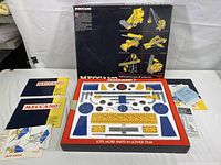 Original box with 660 parts and instruction manuals laid out showing tray with metal model parts.