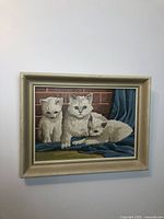 Full view of vintage paint by numbers painting depicting three cats in a wood frame.