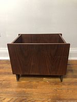 Front view of rectangular teak wood planter or record box with visible wood grain and small legs.