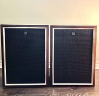 Front view of the pair of vintage Pioneer speakers showing black mesh grilles with silver trim and Pioneer logo.
