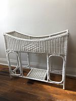Full side view of the white wicker planter box stand showcasing the box and legs.