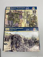 Front view of two Italeri model kits, numbers 6045 and 6134, both depicting WWII German paratroopers in different uniforms.