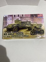 Box front showing artwork of M3 Half Track and 1/4 ton amphibian vehicle models with military theme.